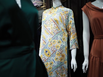 three mannequins dressed in different styles of clothing