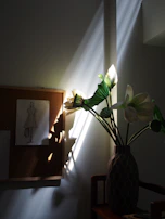Soft natural light filtering through a window onto tools and sketches of jewellery designs.