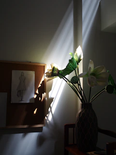 Soft natural light filtering through a window onto tools and sketches of jewellery designs.
