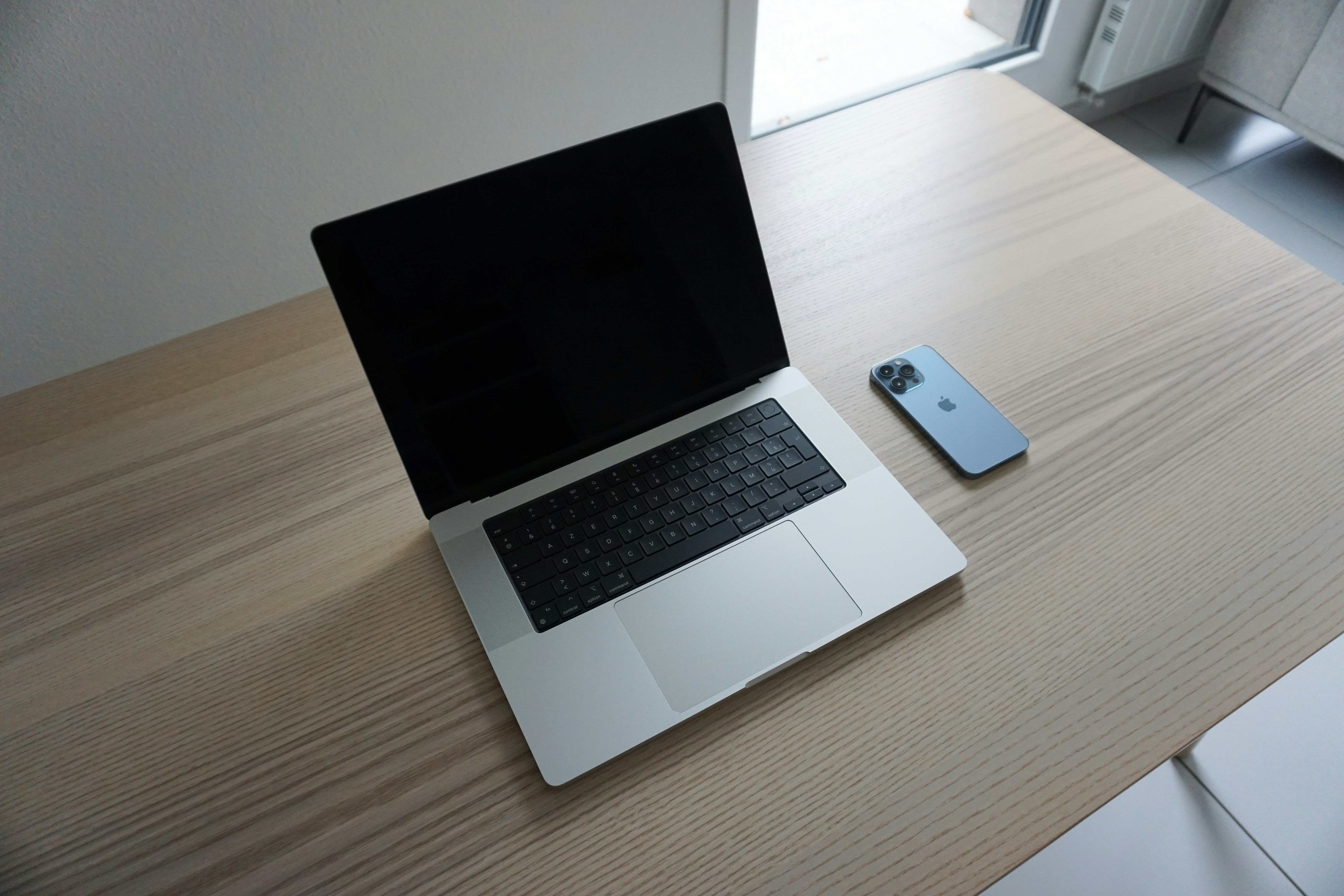 a laptop computer sitting on top of a wooden desk
