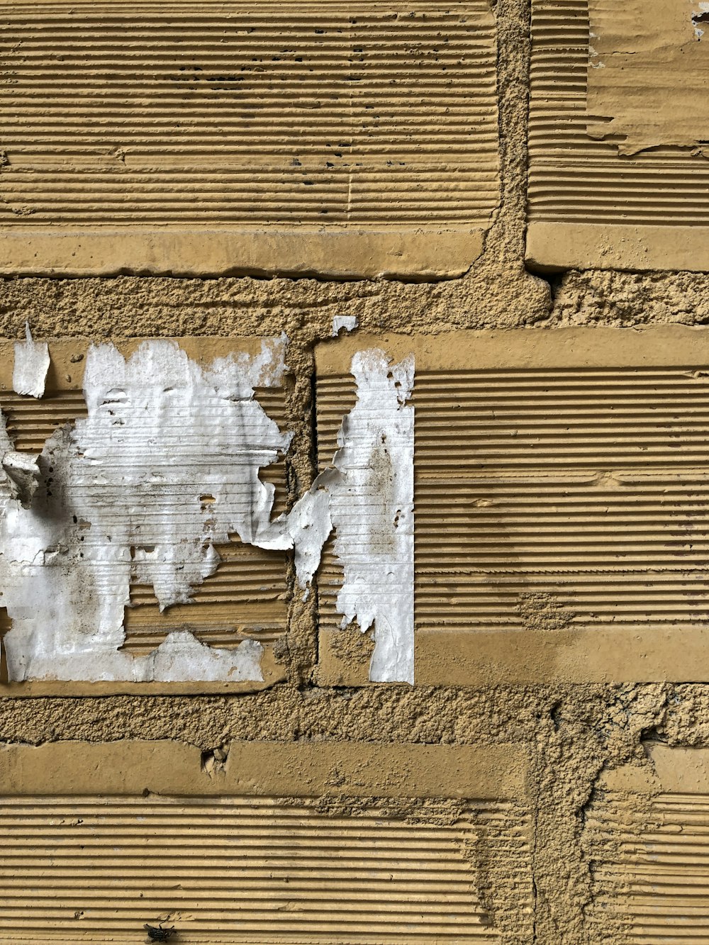 a close up of a wall with peeling paint