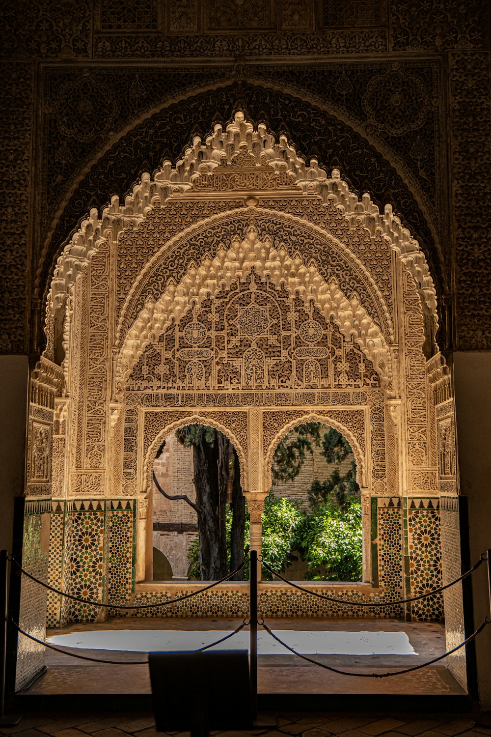 a building with a large archway and a tree in the middle of it