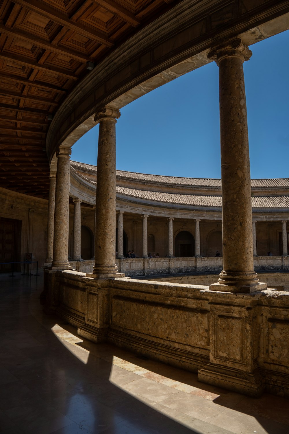 a large building with columns and a sky background