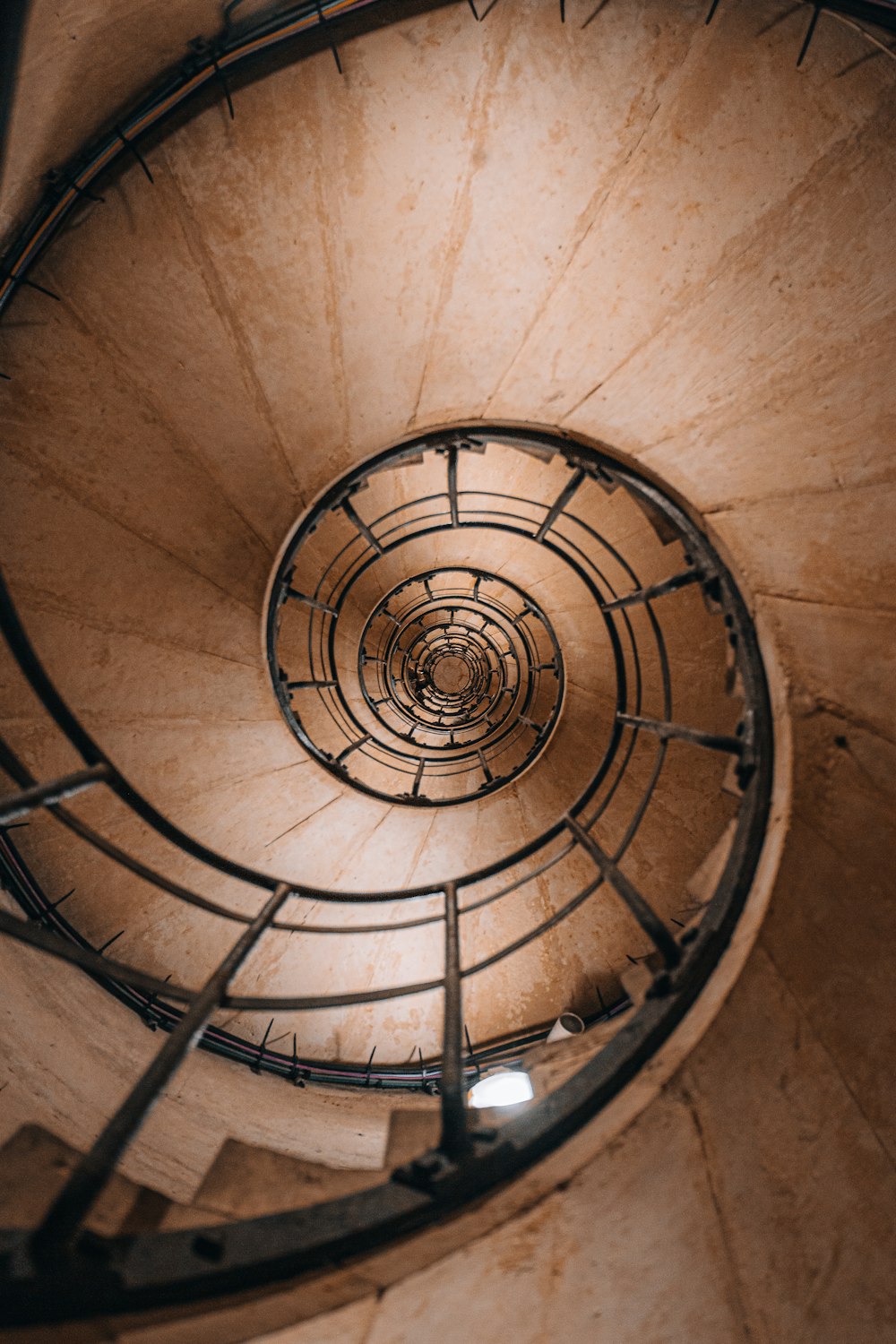 a spiral staircase in a building with metal railings