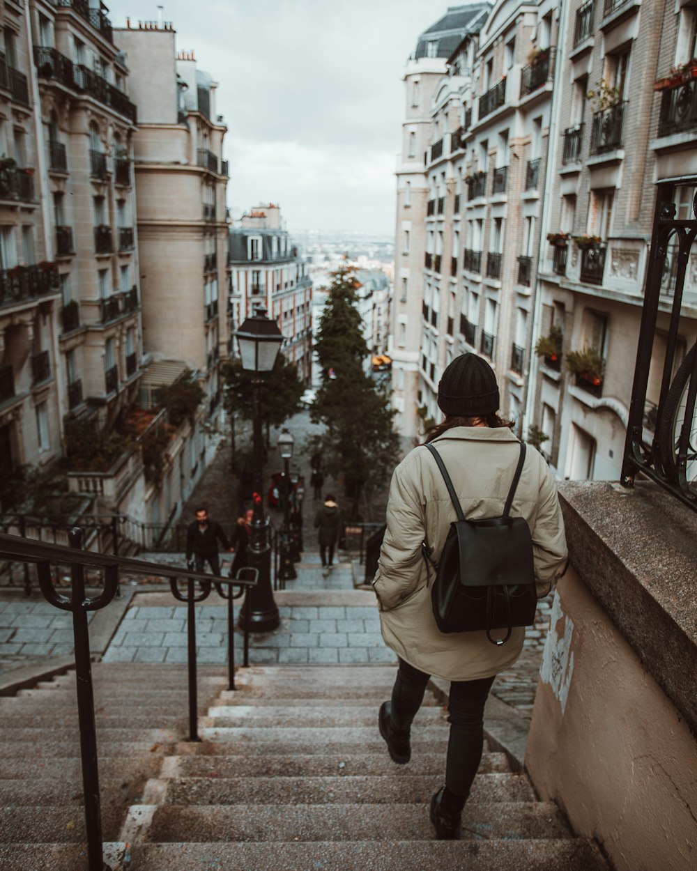 a person with a backpack walking up some stairs