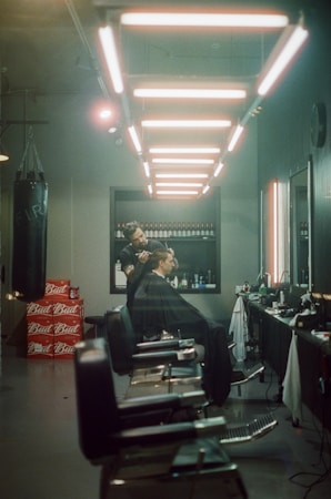 A sleek urban barber shop scene with young friends sharing a QR code on their phones.