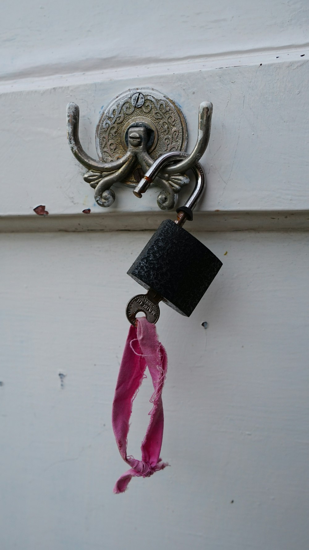 a door handle with a pink ribbon hanging from it