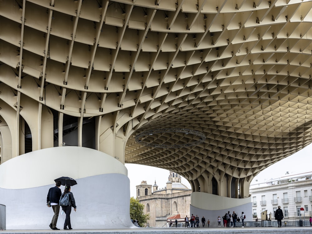 a person with an umbrella standing in front of a building