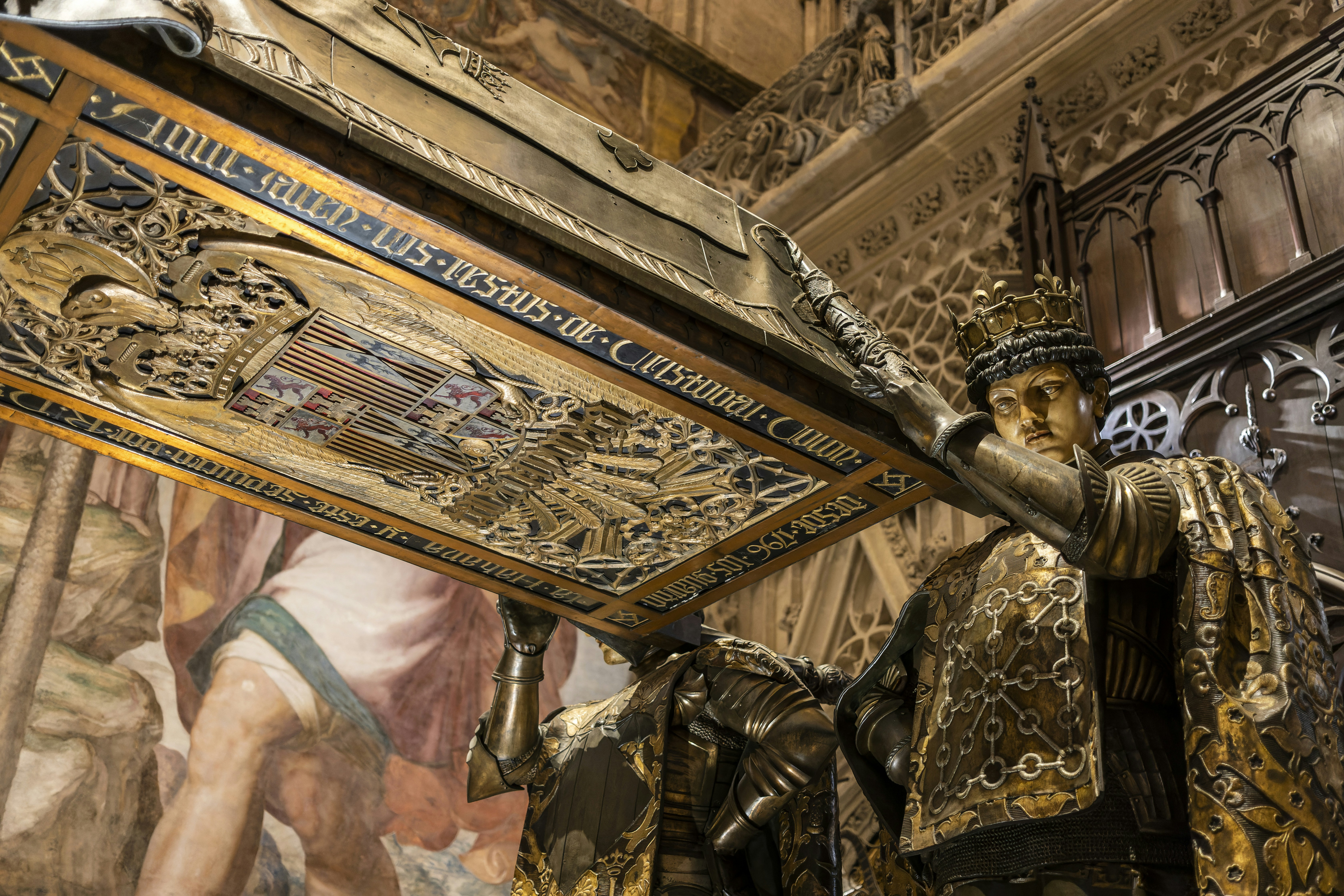 a close up of a statue of a man holding a cross