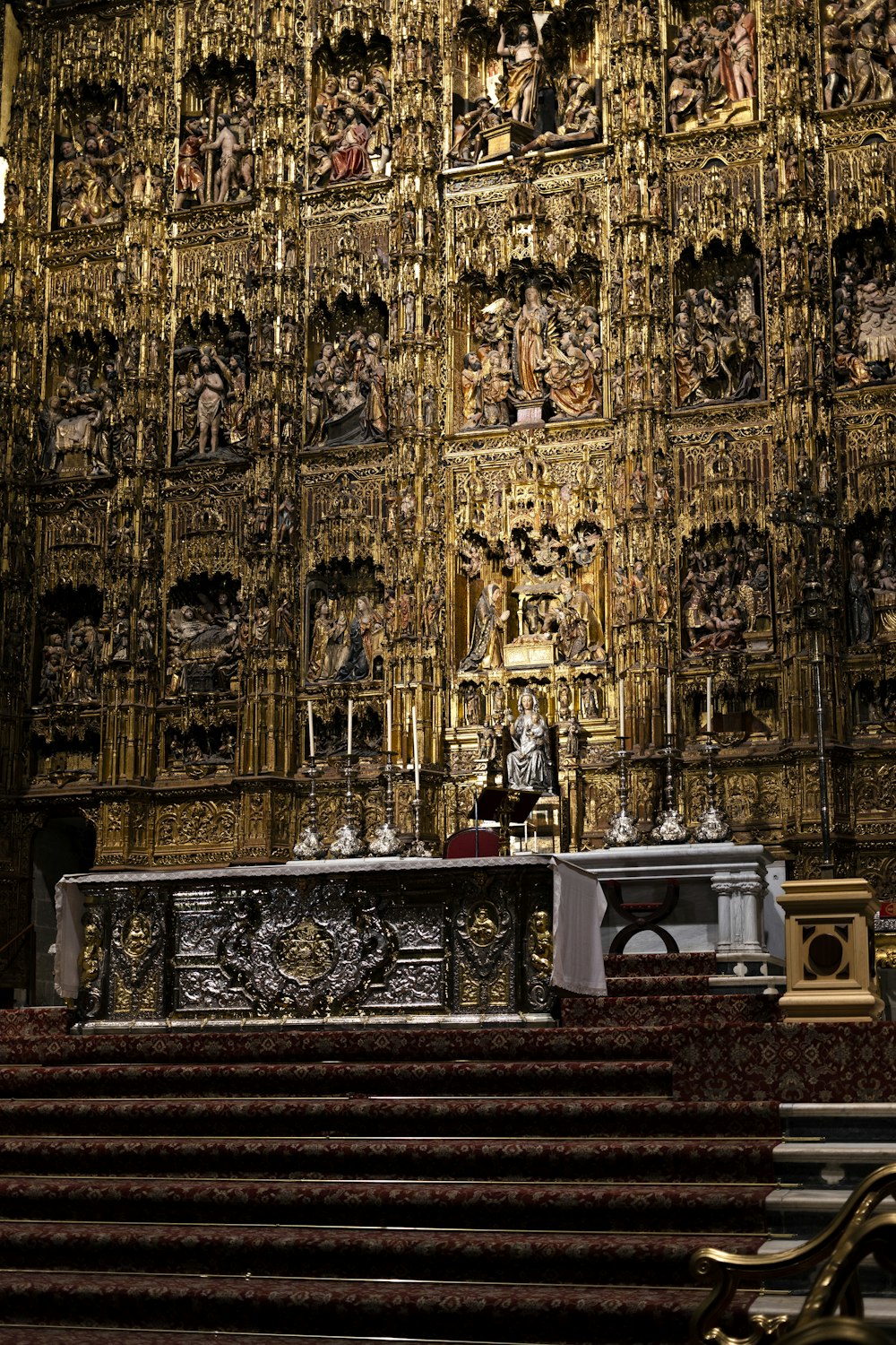 a church with a golden alter and ornate wall