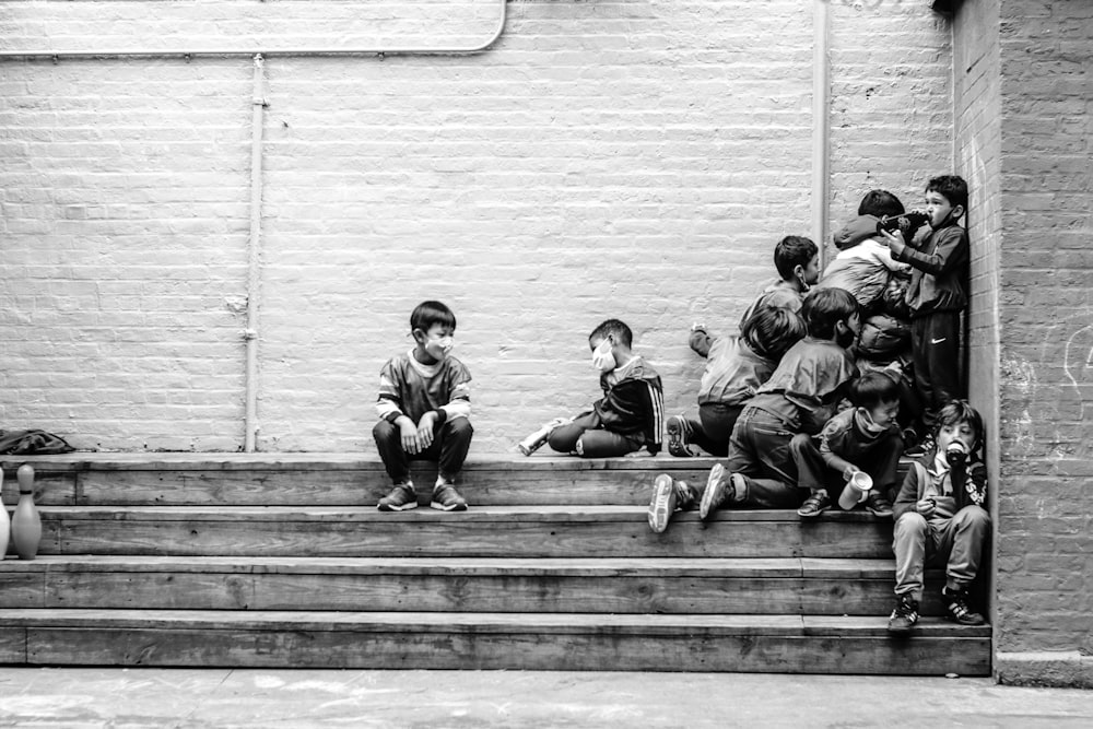 a group of people sitting on the steps of a building