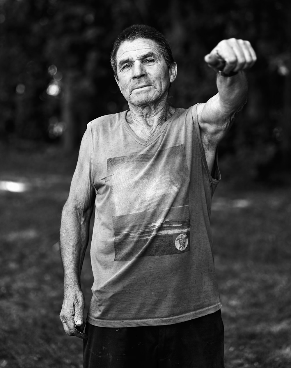 a black and white photo of a man holding a frisbee