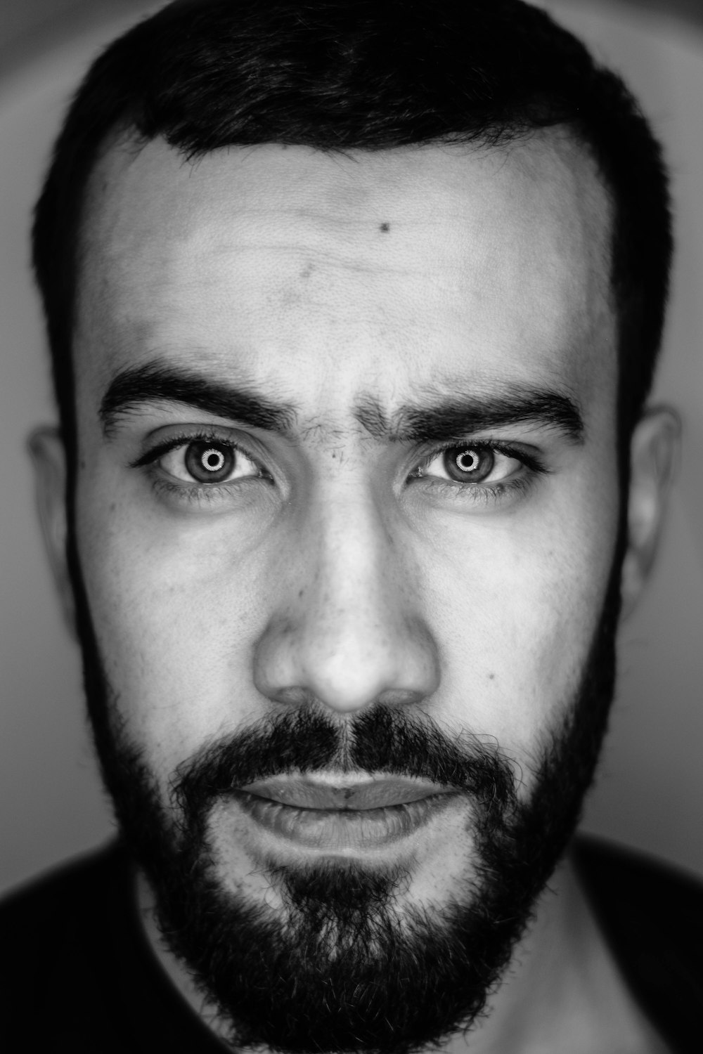 a black and white photo of a man with a beard