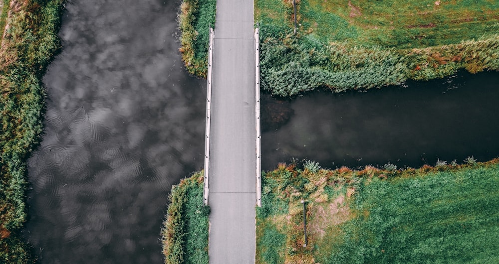 an aerial view of a road and a body of water