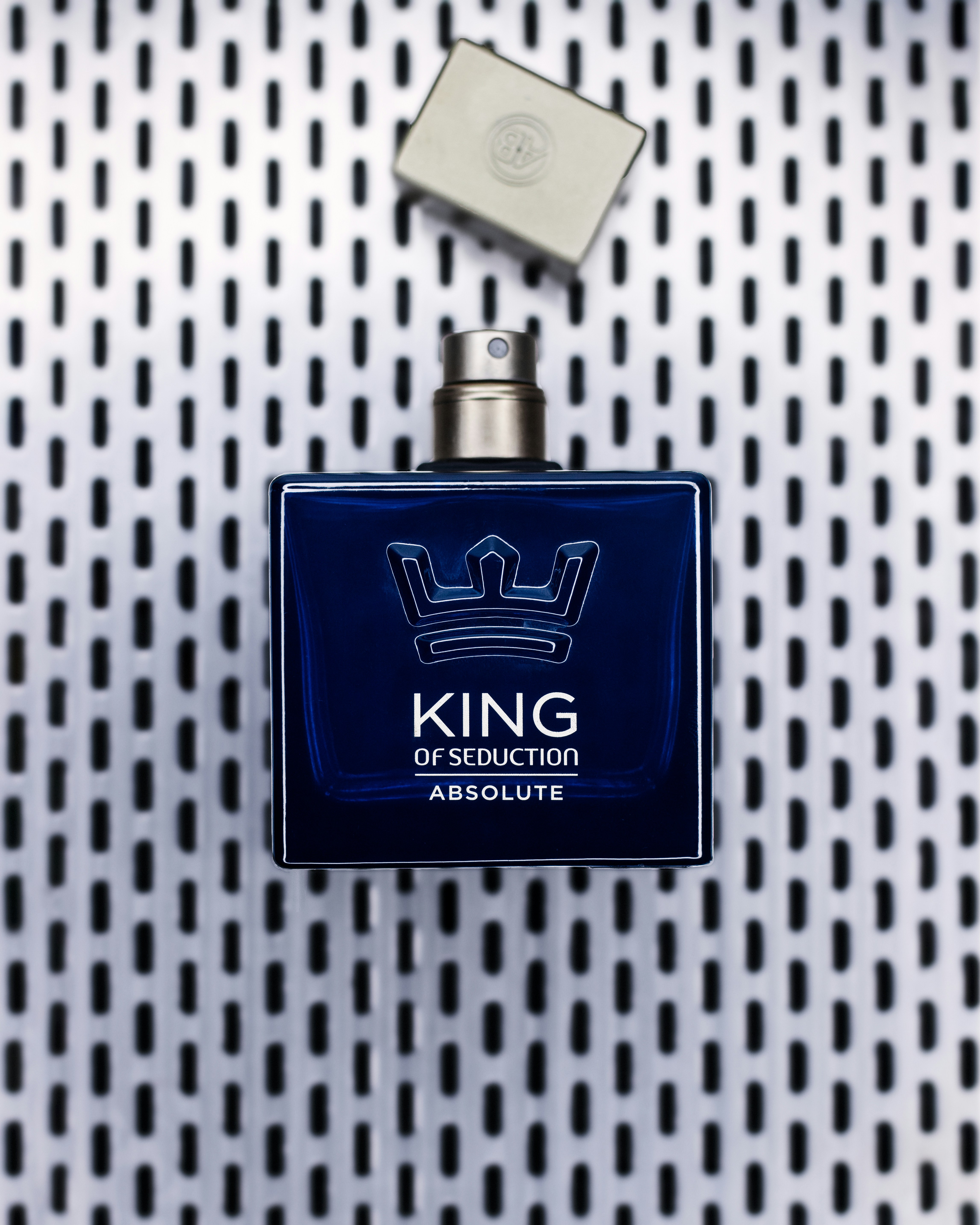 a blue bottle of cologne sitting on top of a table