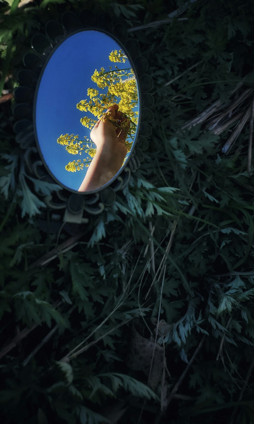 a person's hand is reflected in a mirror