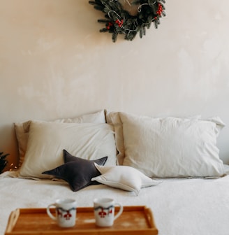 a bed with a wreath on the wall above it