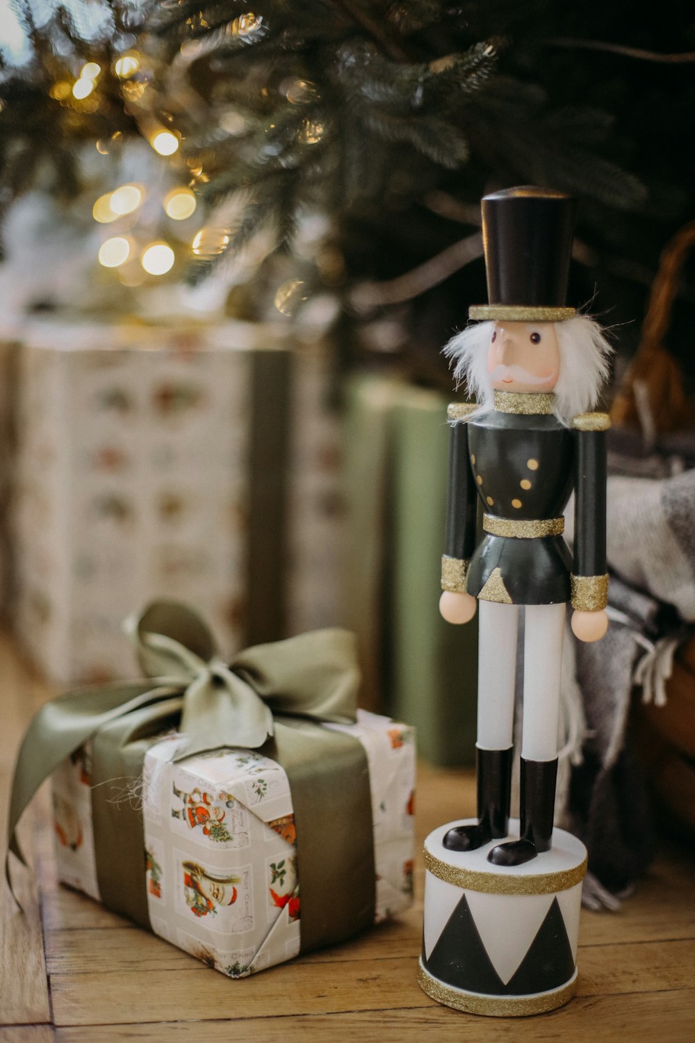 a nutcracker figurine next to a christmas tree