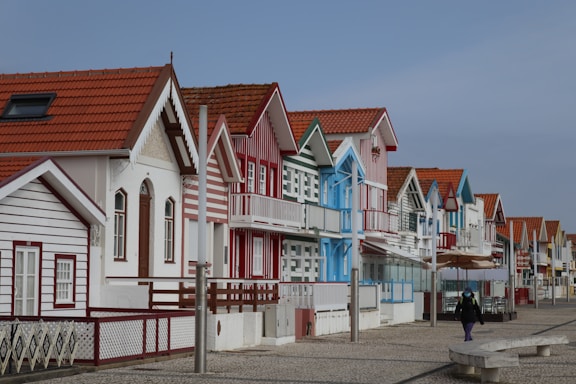 a row of houses with a person walking by them