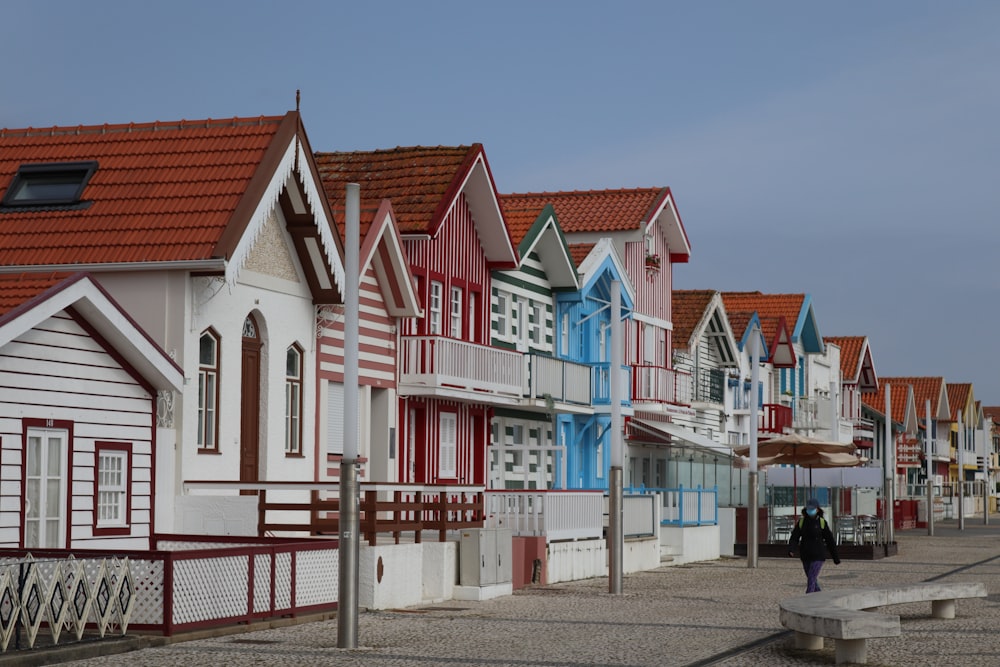 a row of houses with a person walking by them
