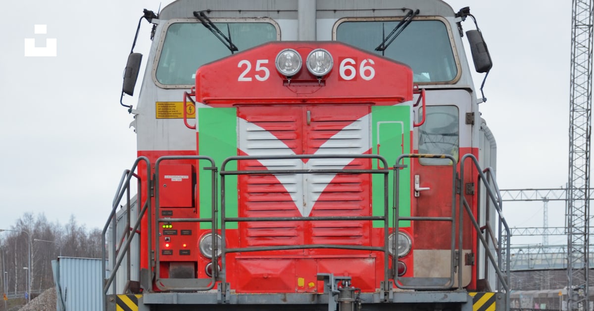 A red and green train traveling down train tracks photo – Free Train ...