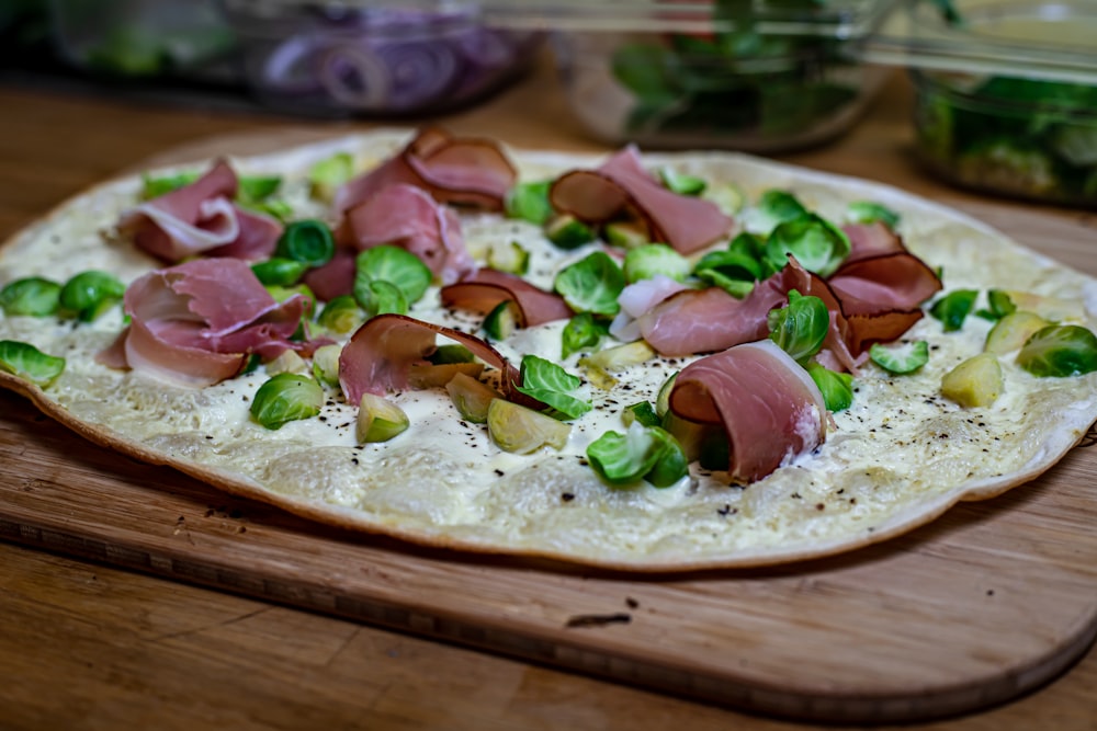 a pizza sitting on top of a wooden cutting board