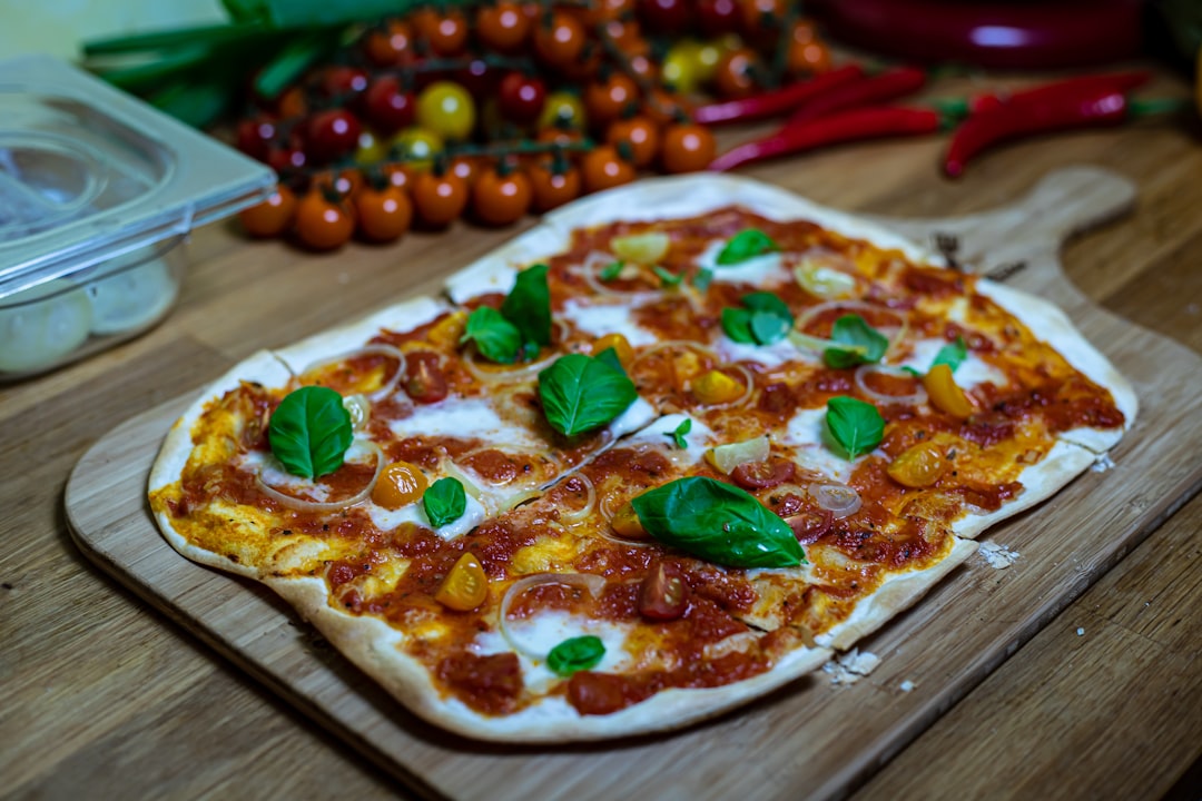 a pizza sitting on top of a wooden cutting board,