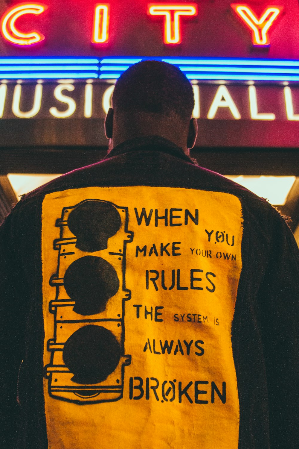 a man standing in front of a city music hall