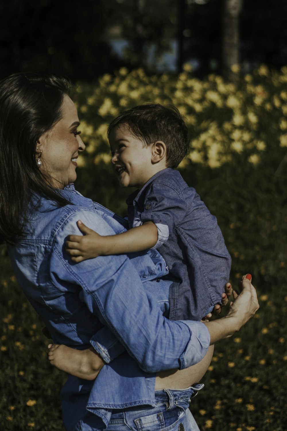 a woman holding a small child in her arms