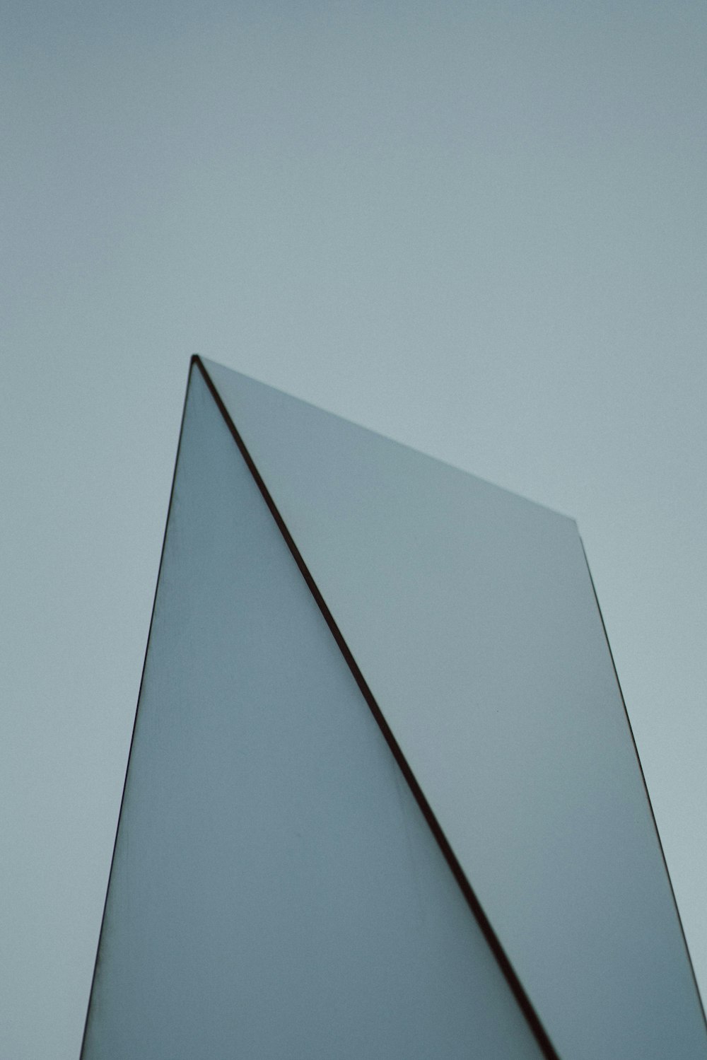 a close up of a glass object against a gray sky