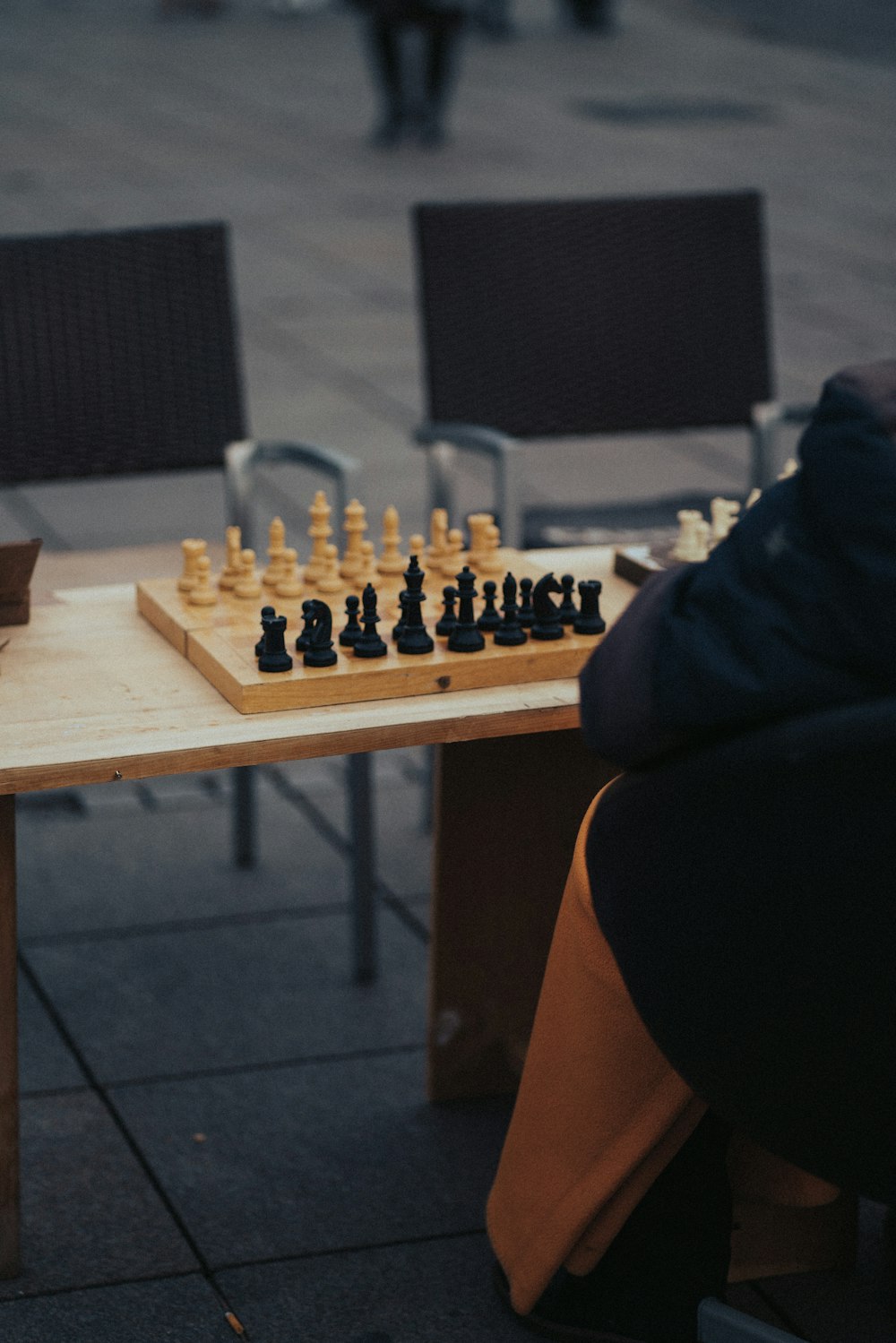 a person sitting at a table playing chess