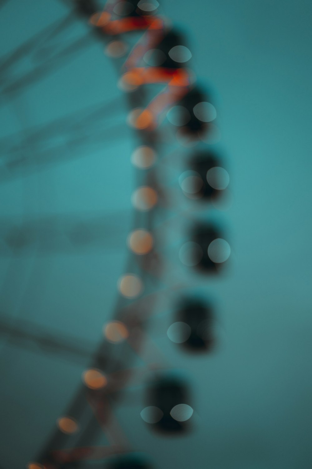 a ferris wheel with blurry lights in the background