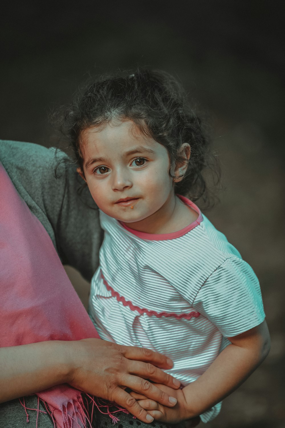 a woman holding a little girl in her arms