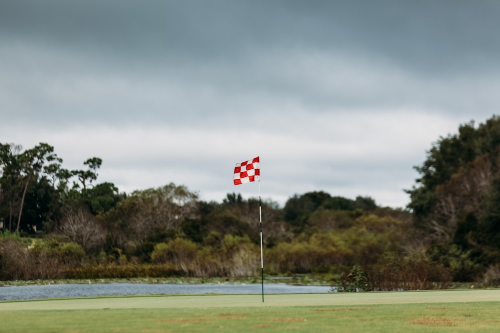 a red and white checkered flag on a golf course