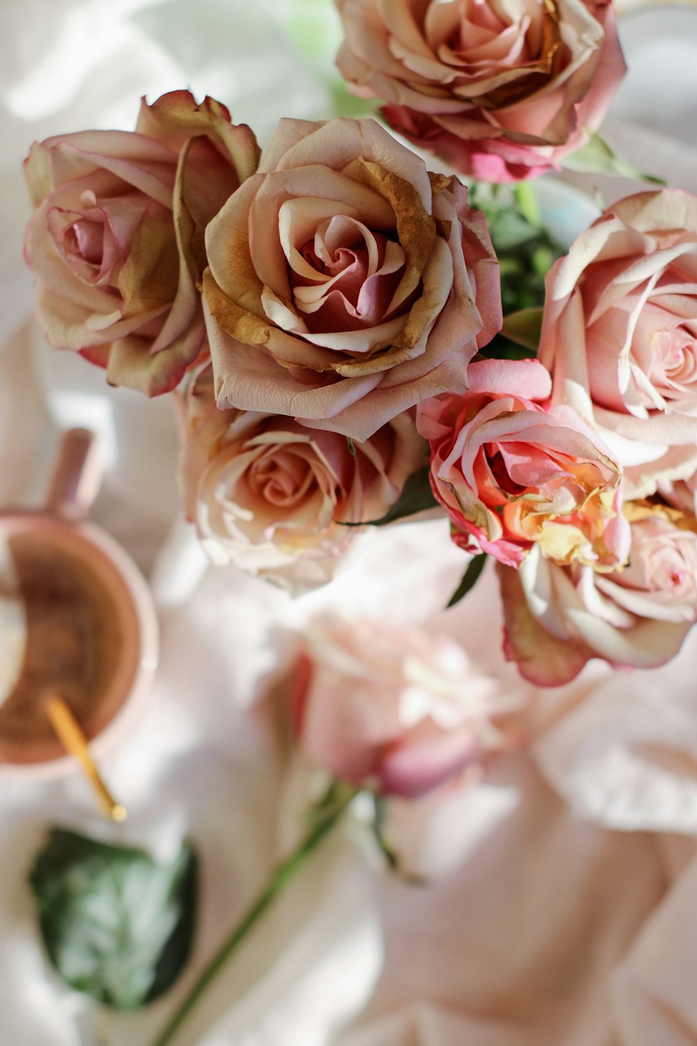 a bouquet of pink roses sitting on top of a table