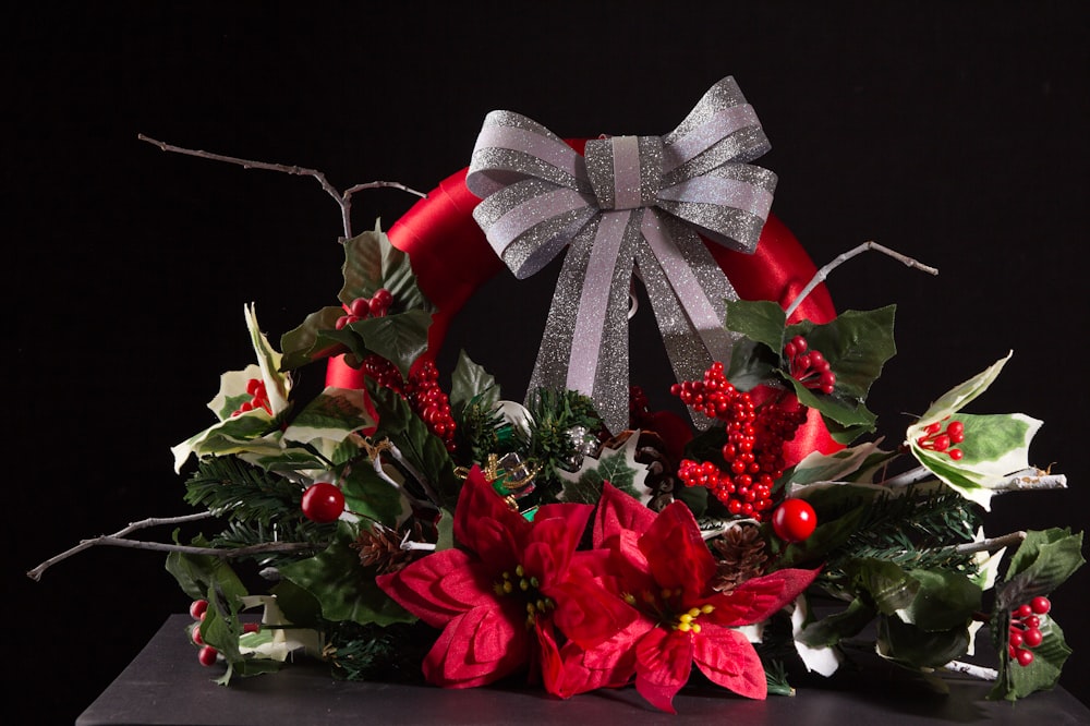 a christmas wreath with poinsettis and holly