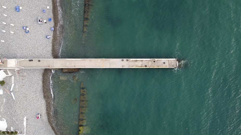 an aerial view of a pier in the water