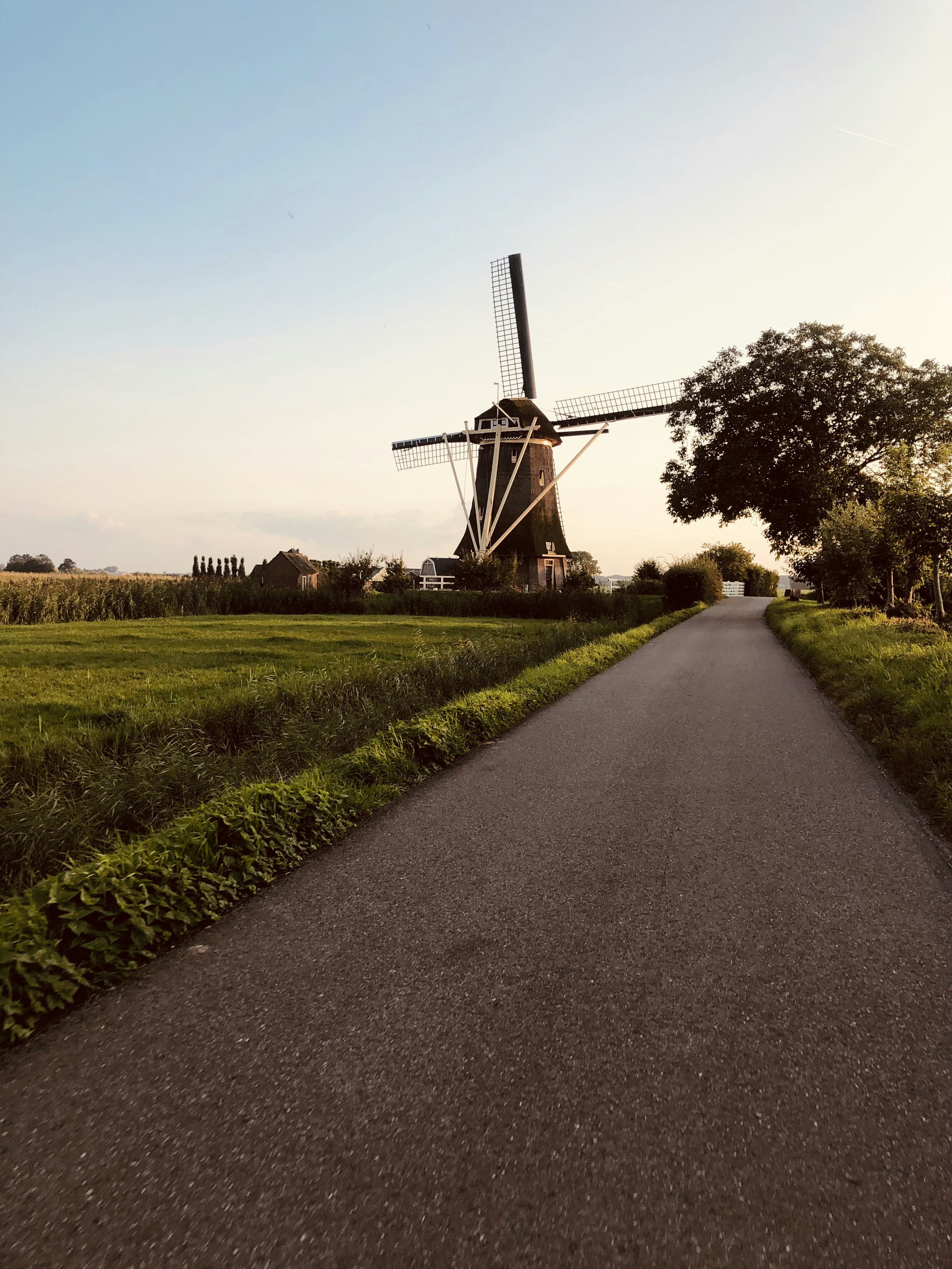 A road with a windmill on the side of it photo – Free Machine Image on ...