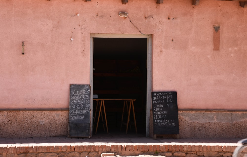 a bicycle parked in front of a pink building