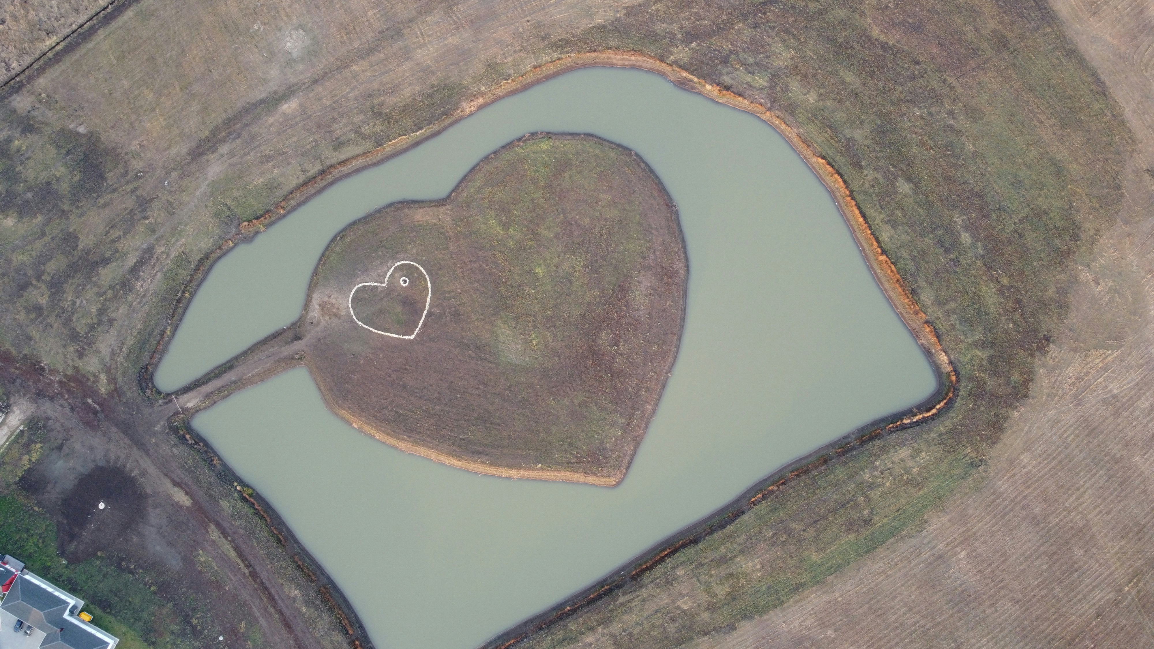 an aerial view of a heart shaped lake