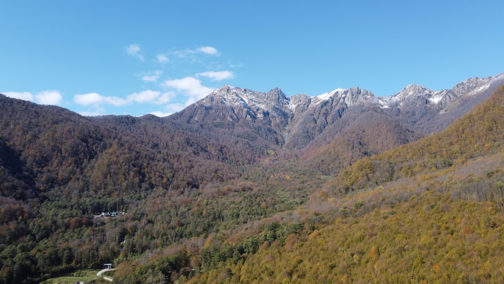 a view of a mountain range with a house in the foreground