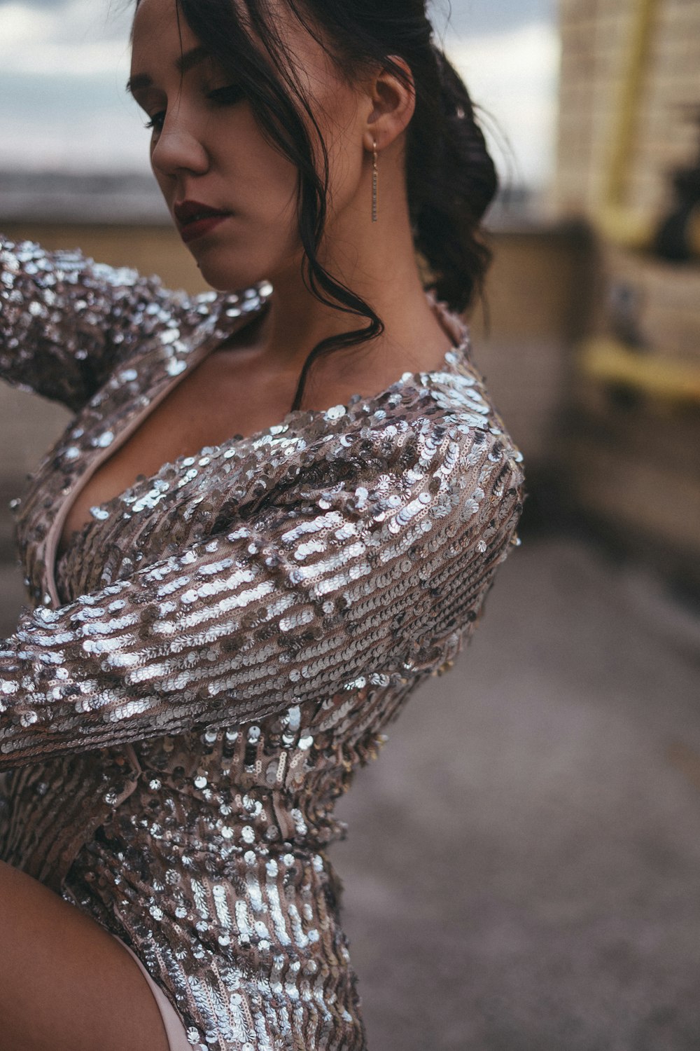 a woman in a silver sequin dress