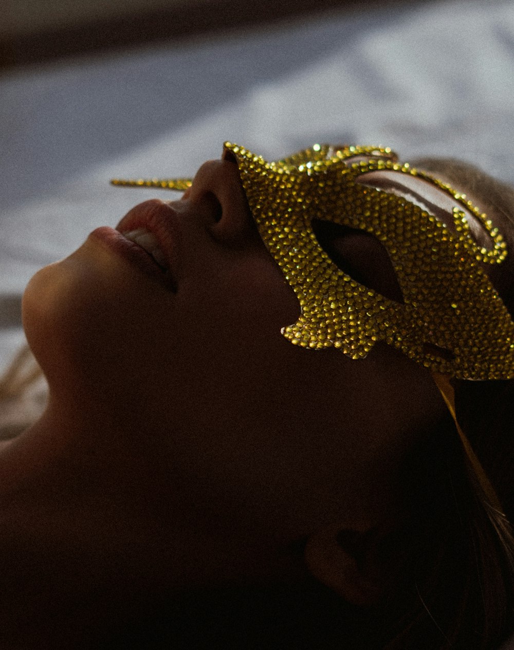 a woman wearing a gold sequined head piece