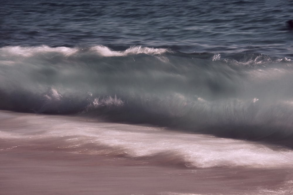 a man riding a wave on top of a surfboard