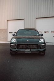 A sleek black Tahoe parked under city lights, ready for a luxury ride.
