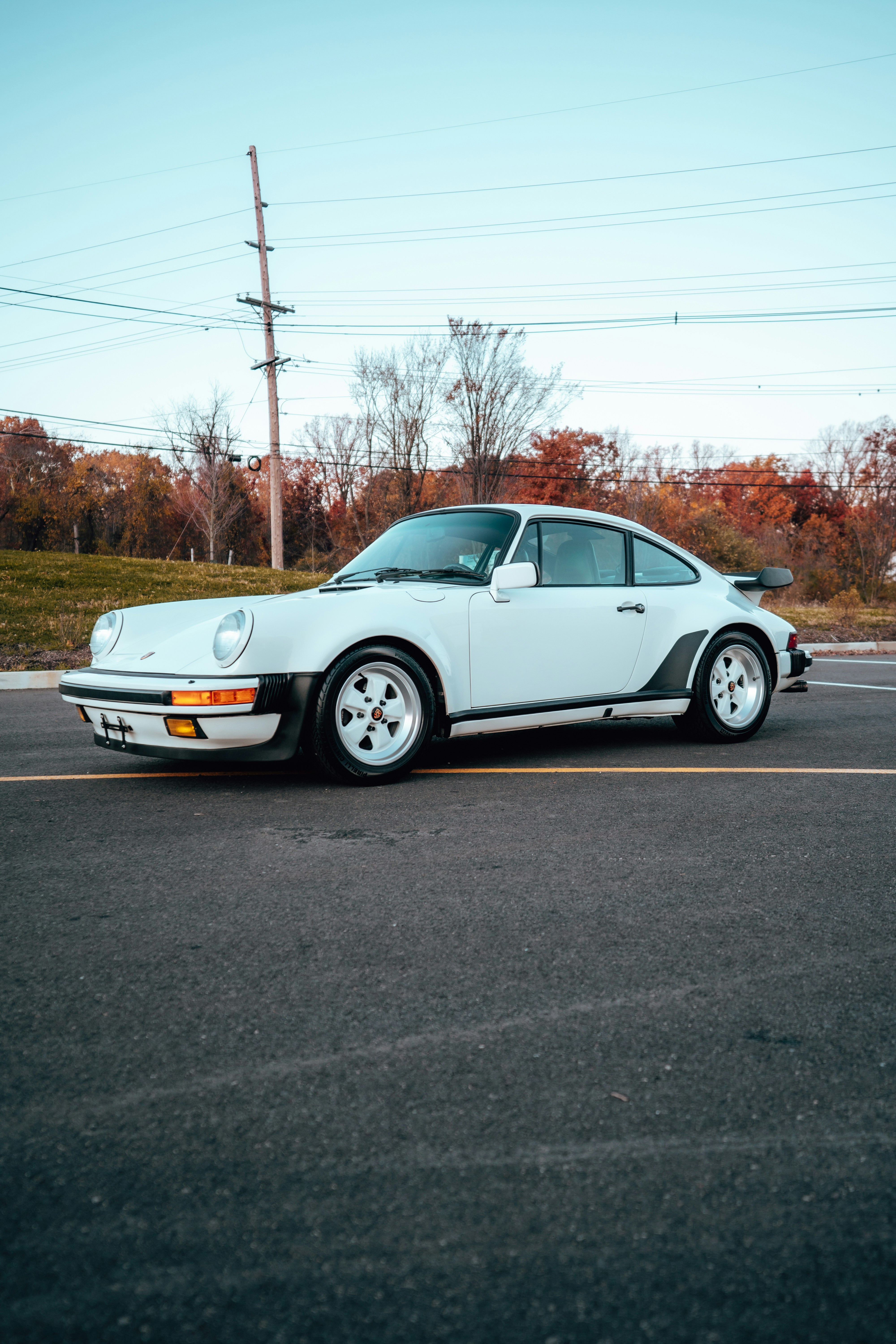 White Porsche 911 Turbo S on winding road, precision German engineering, sports car