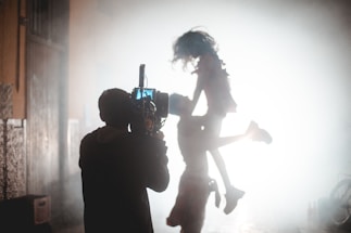a person holding a camera up in the air
