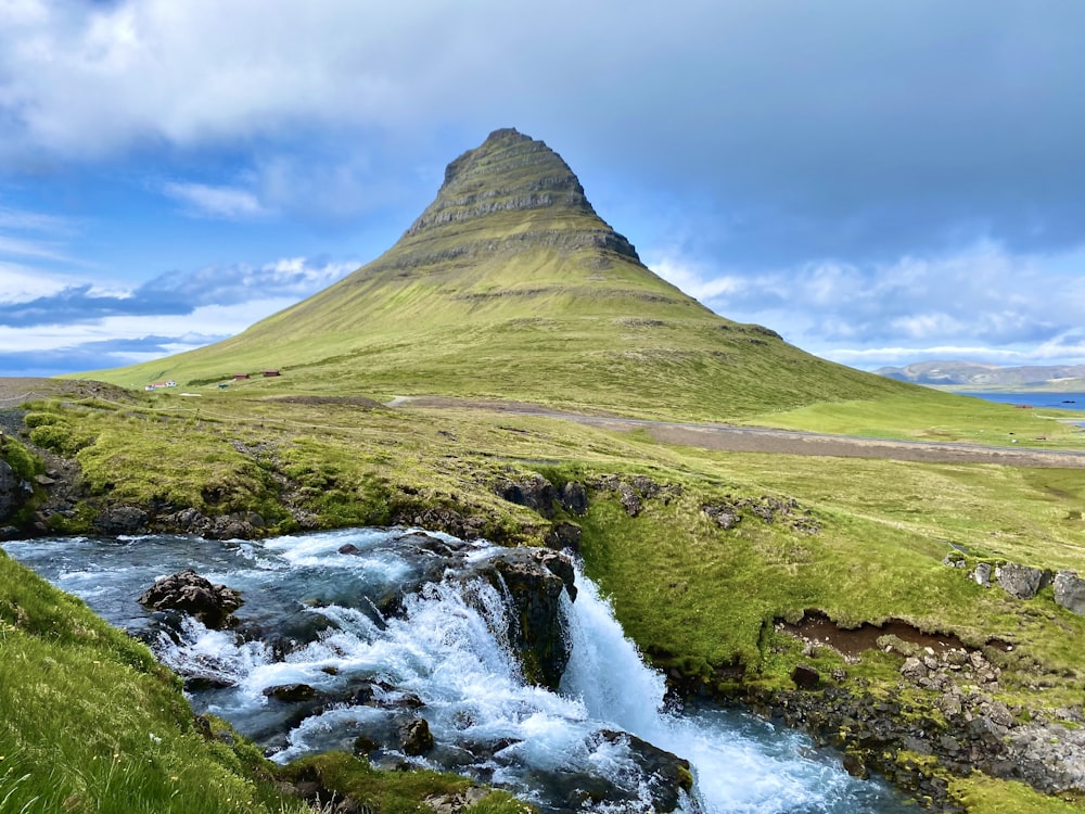 a mountain with a stream running through it