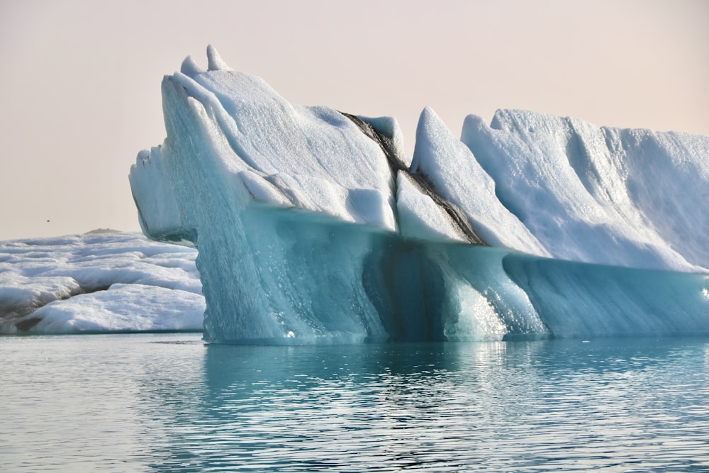 a large iceberg in the middle of a body of water