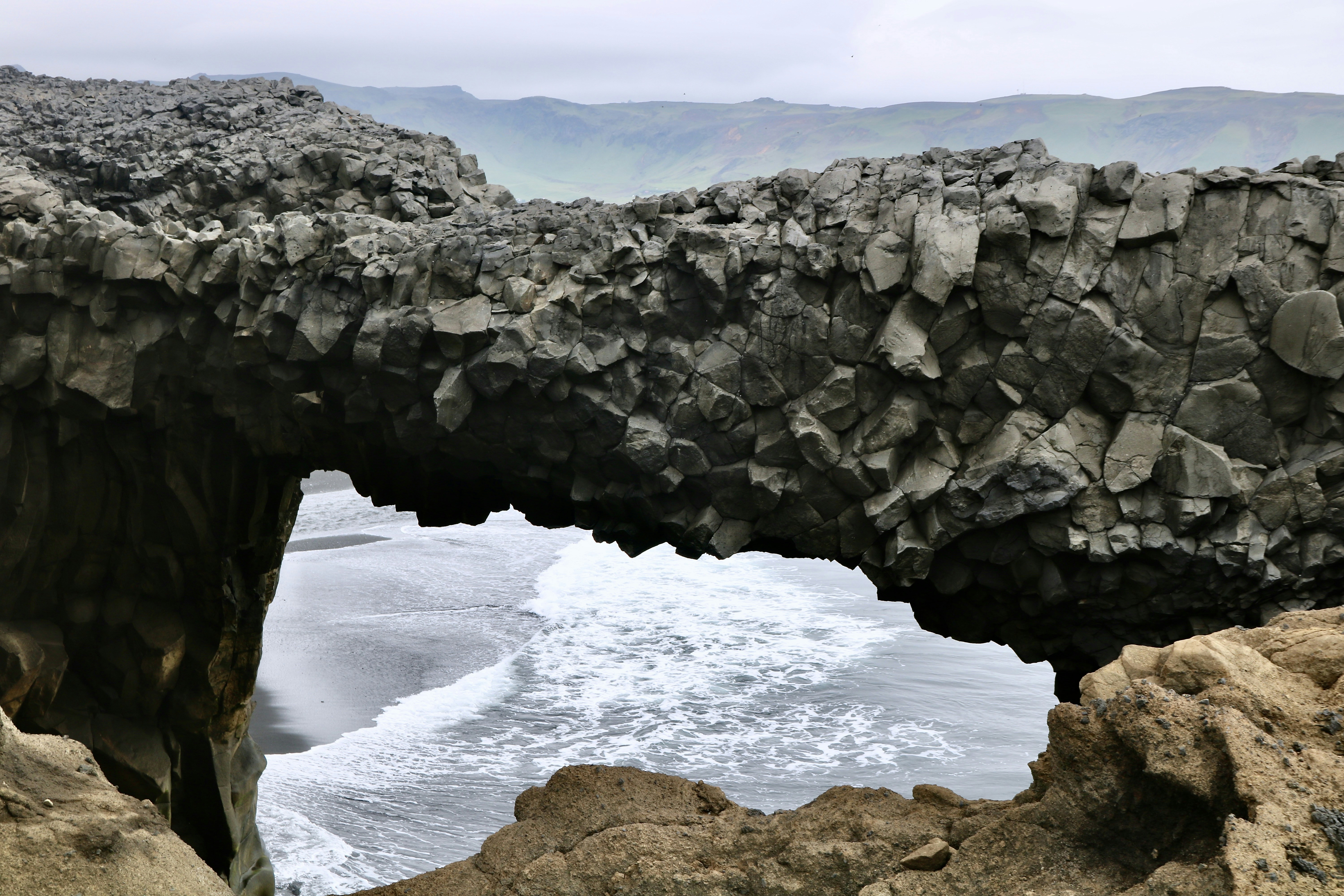 a large rock bridge over a body of water